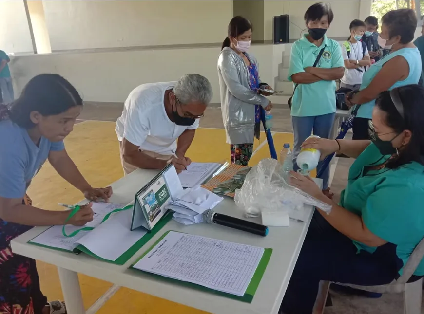 Rosario personnel assisting farmers with registration records